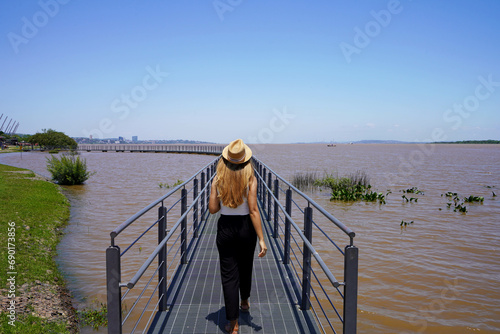 Girl walks on attraction in Orla do Guaiba, Porto Alegre, Rio Grande do Sul, Brazil photo