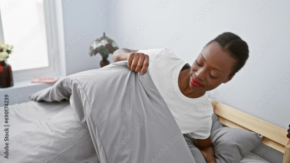 Smiling african american woman, tired and dreamy, posing with hands together while lying on bed, eyes closed, enjoying a peaceful sleep in bedroom. Smiling african american woman, tired and dreamy, posing with hands together while lying on bed, eyes closed, enjoying a peaceful sleep in bedroom.