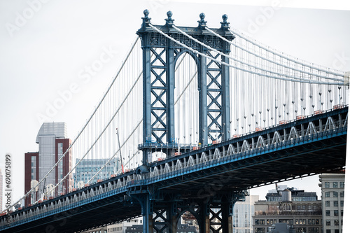 Suspension bridge over river in modern city district © DavidPrado