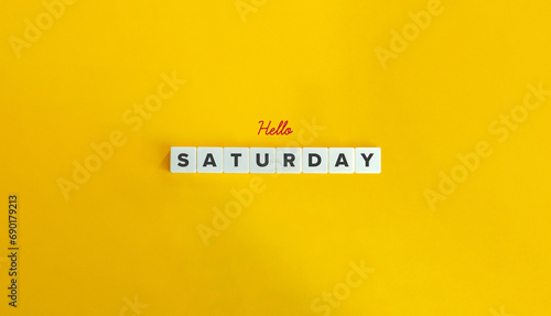 Hello Saturday Message. Block Letter Tiles and Cursive Text on Yellow Background. Minimalist Aesthetics. photo
