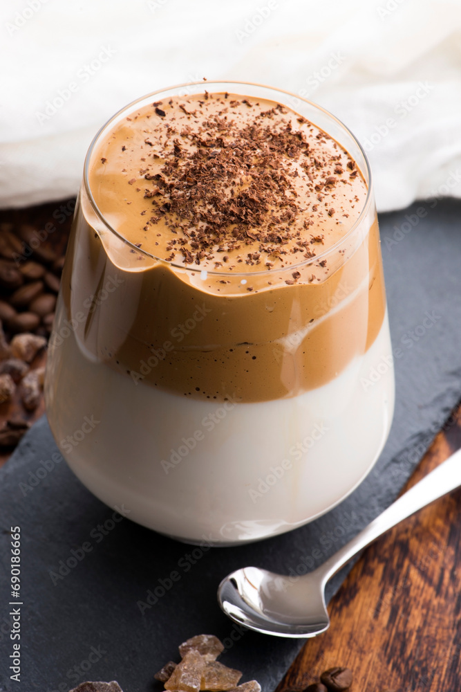 Dalgona coffee in glass cup. Korean trendy drink from instant coffee, milk and brown sugar Dalgona coffee in glass cup. Korean trendy drink from instant coffee, milk and brown sugar