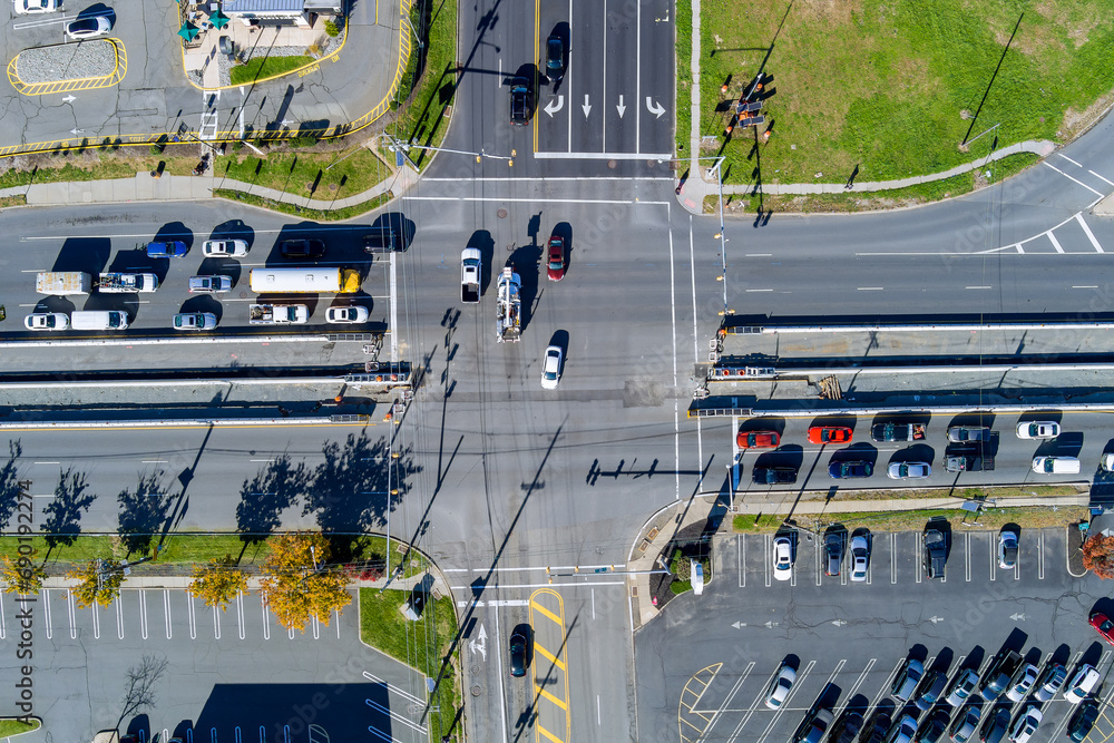 View from an aerial perspective depicts busy road intersection during rush hour with heavy traffic flowing through View from an aerial perspective depicts busy road intersection during rush hour with heavy traffic flowing through