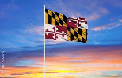 Maryland flag on flagpoles and blue sky. photo