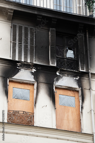 Typical Parisian building exterior after fire. Burnt charred wall. Temporary renovation. Paris, France. Real estate insurance importance concept.