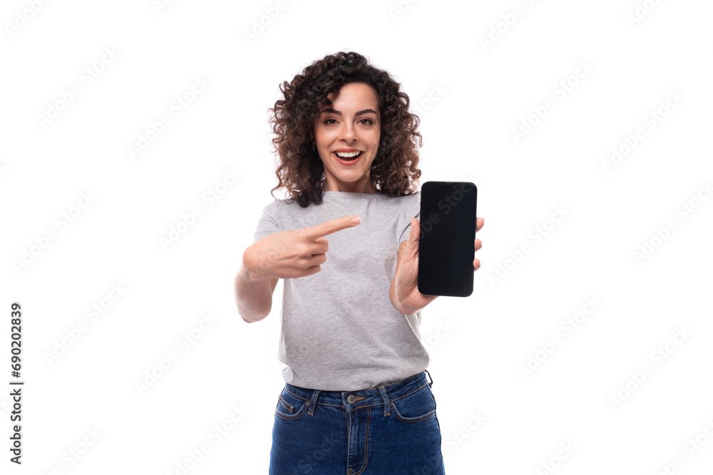 well-groomed european woman with natural black curly hair in a gray basic t-shirt on a white background well-groomed european woman with natural black curly hair in a gray basic t-shirt on a white background