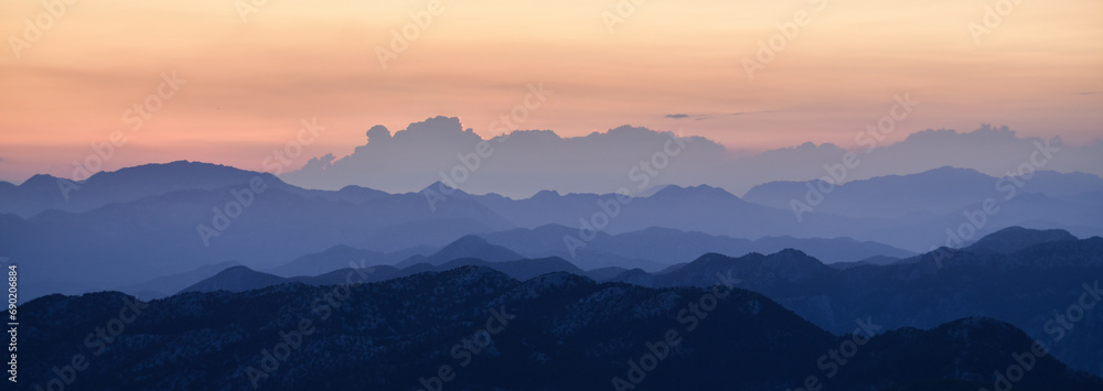 The Lights of the Setting Sun over the Mountain Range