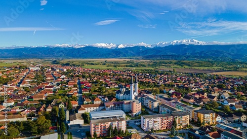 Aerial stunning view of a historic town, surrounded by the picturesque Fagaras mountains photo