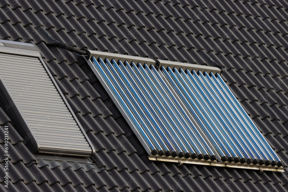 Fototapeta premium Evacuated solar tube collectors on a roof.