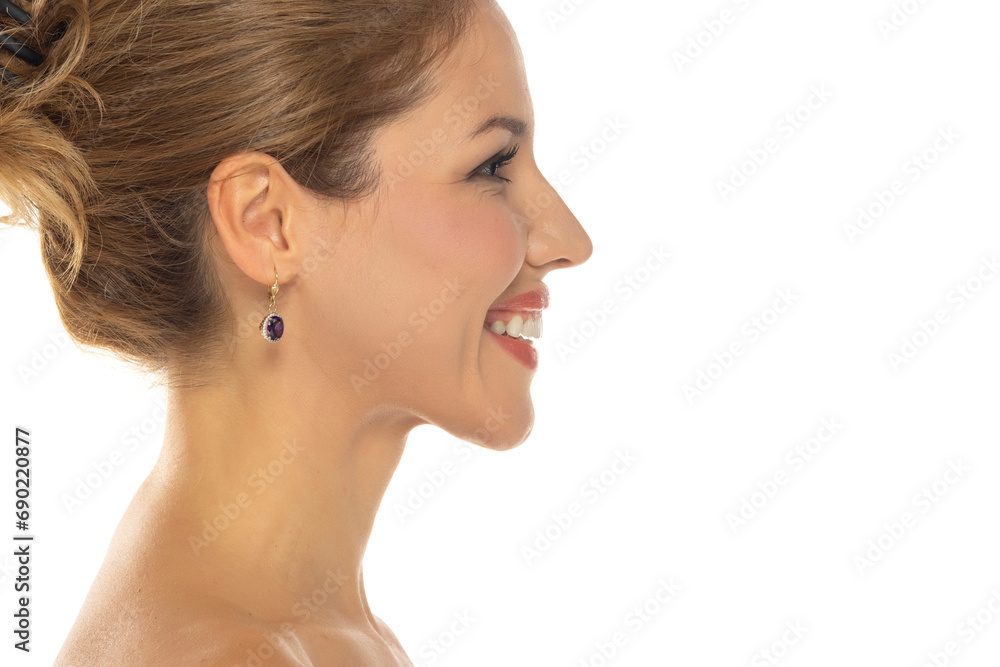 Profile side view of a young beautiful woman with closed eyes on a white studio background Profile side view of a young beautiful woman with closed eyes on a white studio background