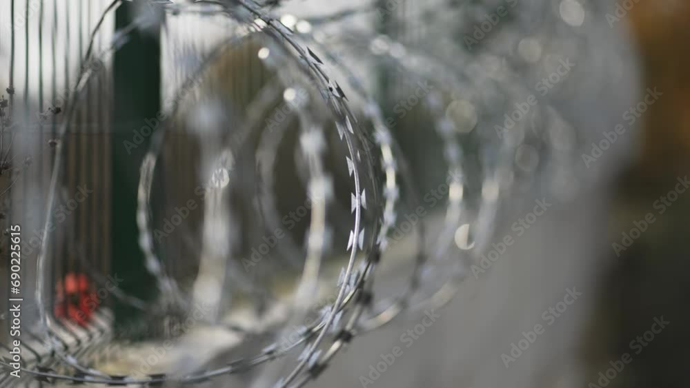 Dramatic scene of barbed wire fence on a prison wall, selective focus cinematic shot Dramatic scene of barbed wire fence on a prison wall, selective focus cinematic shot
