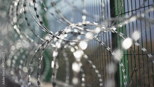 Gloomy abstract blurred background with jail fence with barbed wire, selective focus photo