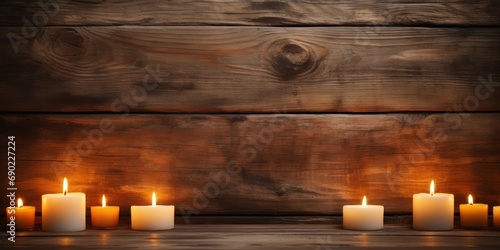 Candles cast a warm dance of light on rugged wooden planks.