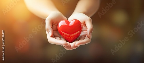 hands holding red heart health care love and support organ donation family insurance and CSR concept world heart day world health day National Organ Donor Day. Website header. Creative Banner