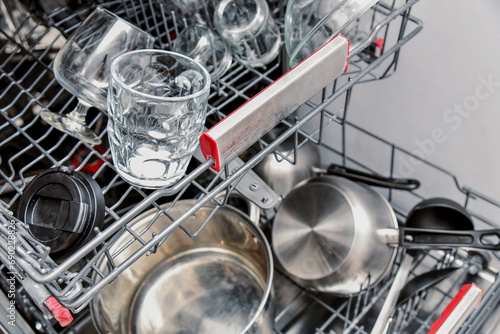 Various kitchen utensils loaded into the dishwasher inside.