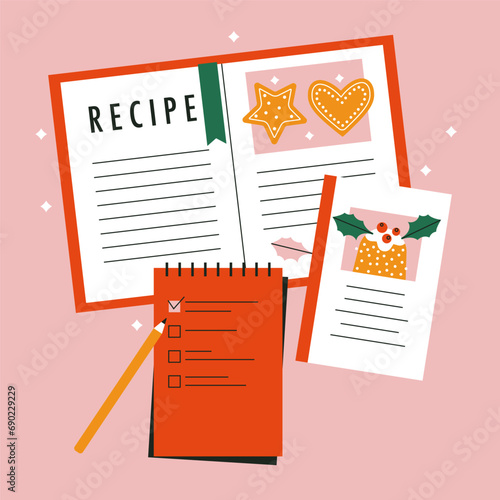 Christmas shopping list written on a red paper sheet. Open cookbook with photos of festive food recipes. Notebook, notepad, planner. Organizing for celebration, to do. Decorative design elements. 