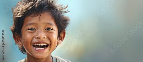 Little Southeast Asian boy with dental problems smiling showing his tooth caries and cavities. Website header. Creative Banner. Copyspace image photo