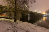 Night snowy Nature with Trees around River Vltava, Holesovice, the most cool Prague District, Czech Republic