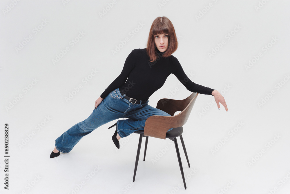 Fototapeta premium Women model in front of white background in studio. A girl with a short haircut, a professional model. Fashion, catwalk.