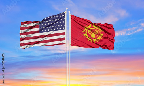 United States and Kyrgyzstan two flags on flagpoles and blue cloudy sky . Diplomacy concept, international relations