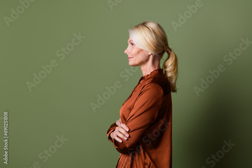 Photo portrait of lovely senior lady confident boss expert dressed stylish silk brown garment isolated on khaki color background © deagreez