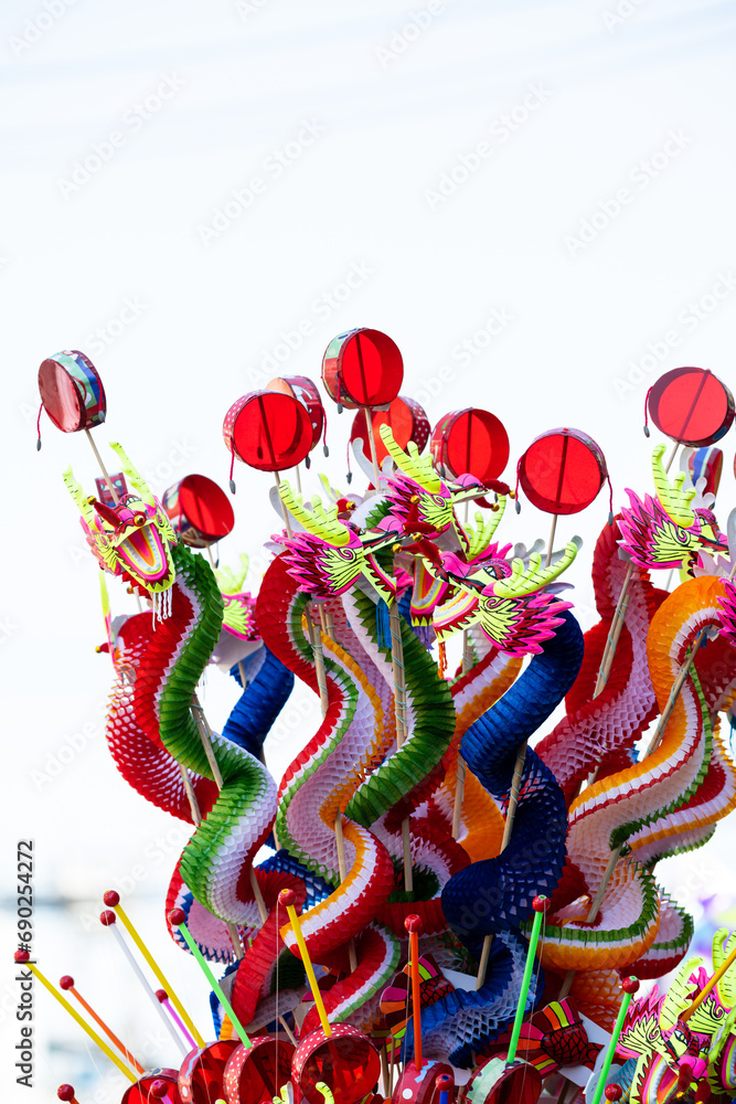 Fototapeta premium Colorful Chinese dragon toys in Chinese New Year festival.Chinese New Year Decoration, Dragon toy paper on festive background.