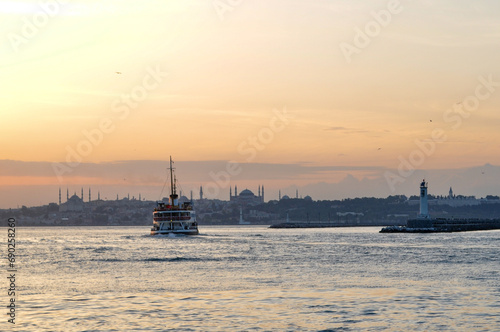 Ferry, old town and sunset from Kadikoy photo