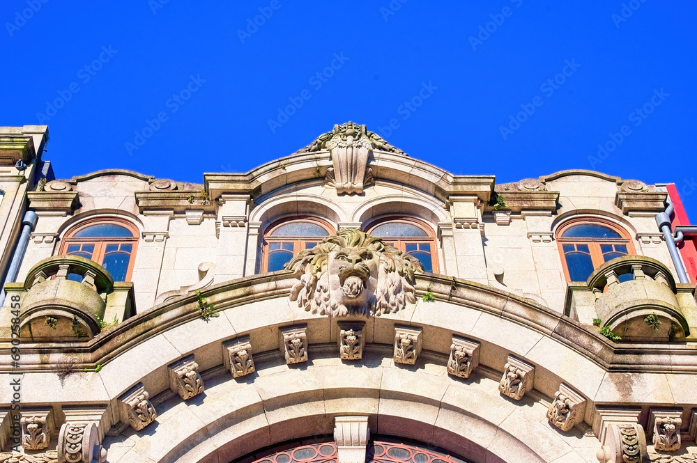 Sculpture of a lion in facade of old building, Porto, Portugal