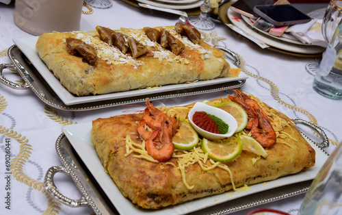Moroccan pie stuffed with fish and chicken  served at Moroccan weddings and events