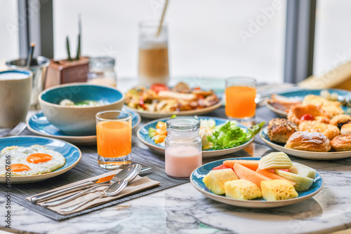 Varied breakfast spread on table with fresh juice and coffee. Healthy food and lifestyle. © TravelMedia