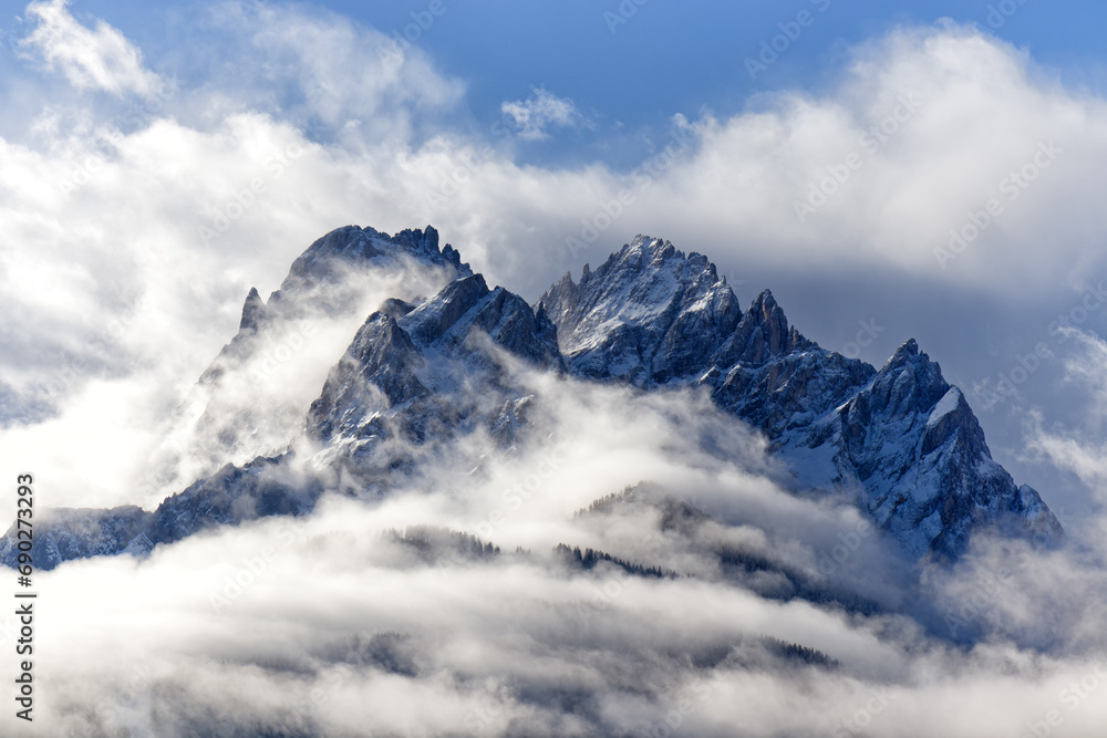 Snow covered peaks of the Sesto Dolomites with clouds in winter, mountains of the Alps, South Tyrol, Italy, Europe Snow covered peaks of the Sesto Dolomites with clouds in winter, mountains of the Alps, South Tyrol, Italy, Europe