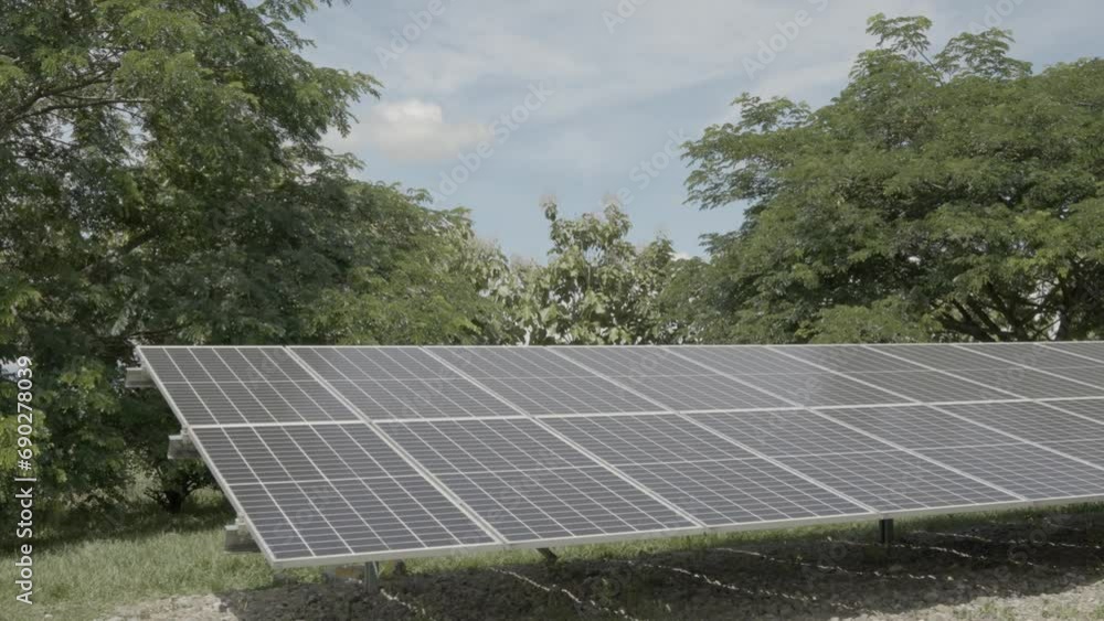 Slow motion pan of two solar panel arrays with clouds and blue skies in the background. Slow motion pan of two solar panel arrays with clouds and blue skies in the background.