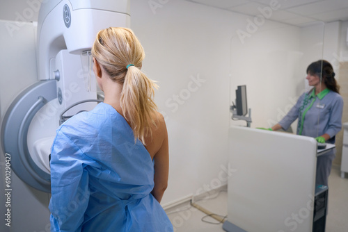 Female patient is receiving screening mammogram in medical center