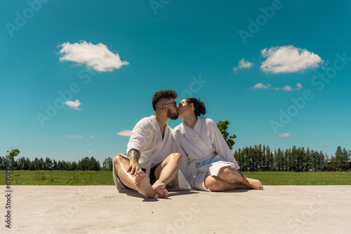 beautiful young couple in bathrobes sunbathing