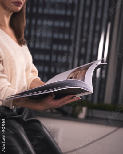 Fotografi Close-up of a magazine flipping through middle-aged women in office work