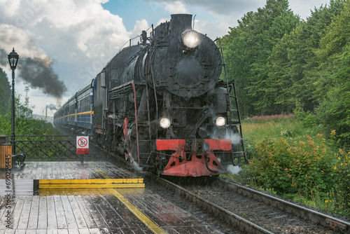 Retro steam train approaches to the platform.