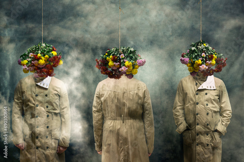 Three men in raincoats with hanging bouquets of flowers. 