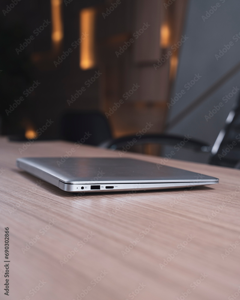 Close-up of a laptop lying on a wooden table in the office Close-up of a laptop lying on a wooden table in the office