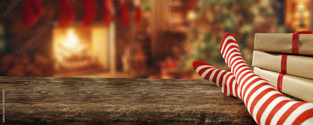 Woman legs and home interior with fireplace. Chrismtas time. Woman legs and home interior with fireplace. Chrismtas time.