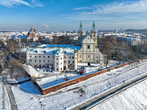 Skalka. St. Stanislaus church and Paulinite monastery in Krakow, Poland, in winter. Historic burial place of distinguished Poles. Aerial view with boulevard and promenade, surrounding wall and snow photo