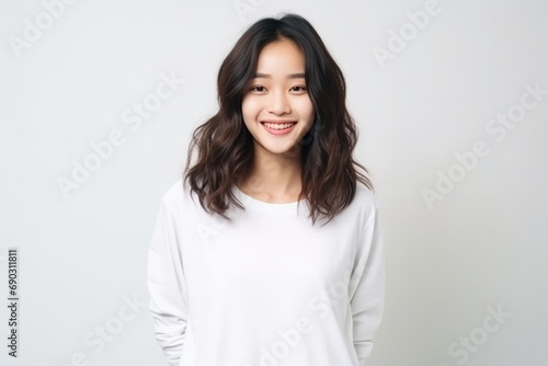Cheerful Asian Teen In Front Of Plain White Studio © Anastasiia
