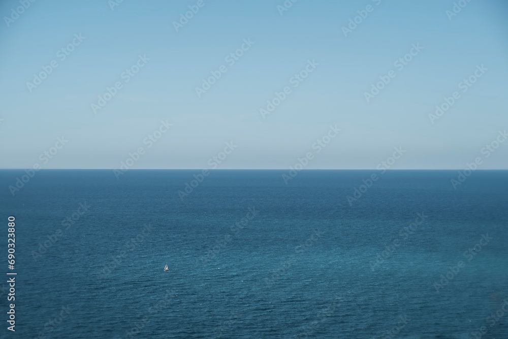 blue sea and sky and a lone boat