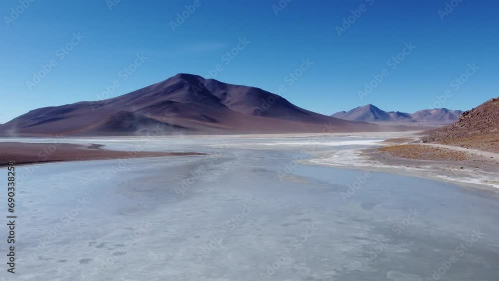 Steam rising up from the shallow blue-grey frozen water of Laguna Capina lagoon on the Altiplano high plains of Bolivia Steam rising up from the shallow blue-grey frozen water of Laguna Capina lagoon on the Altiplano high plains of Bolivia