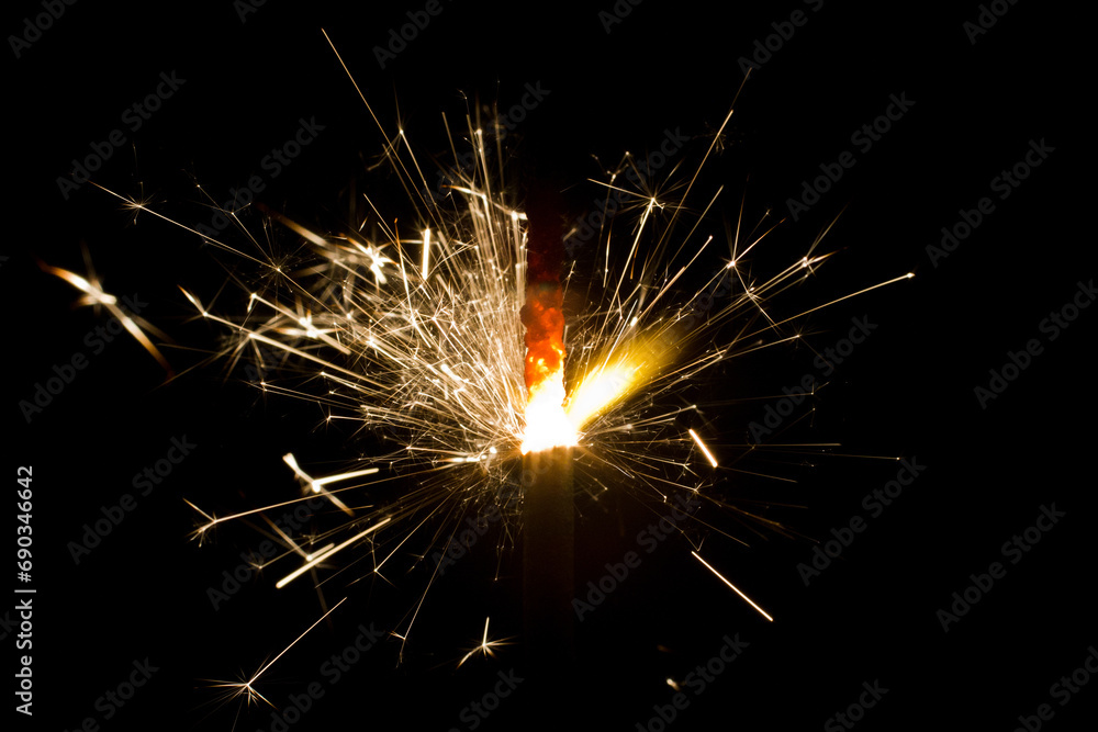 Glowing Sparkler Emanating Golden Sparks Against Dark Background Glowing Sparkler Emanating Golden Sparks Against Dark Background
