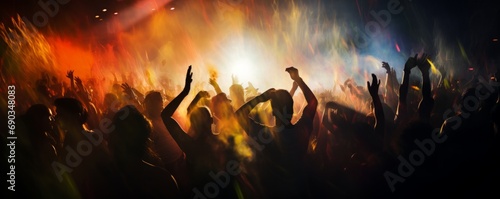 People at a concert in smoke raising their hands. Blurred background and movements. Energetic music party. Live music and fun. Concept of celebration, lively crowd, madness. Panoramic banner photo