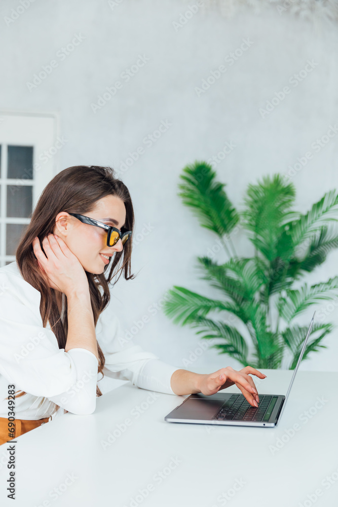 Businesswoman working on laptop in office finance business online Businesswoman working on laptop in office finance business online