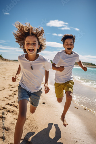 A couple of young and happy children run on a beach