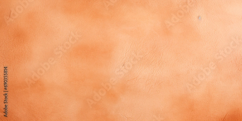 A close up of a wall with a clock on it. Monochrome peach fuzz background.