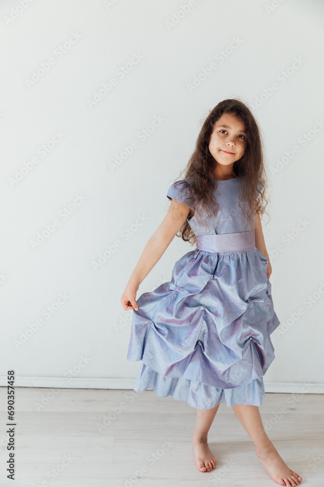 Beautiful little girl in purple dress in white room Beautiful little girl in purple dress in white room
