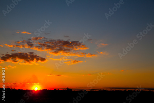 Fiery Sunset Over Silhouetted Landscape in Empire, Michigan