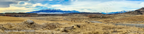 View panorama of  Absaroka mountain range with snow . This is the eastern boundary of Yellowstone National Park as seen from Cody, Wyoming. photo
